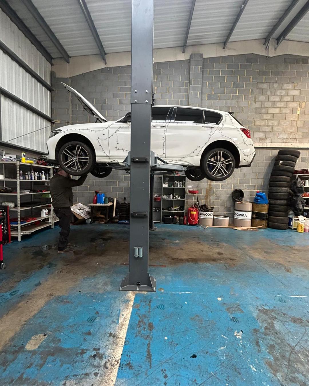Car on the two-post lift in the workshop at KITH Cars Garage & Bodyworks, Hackbridge