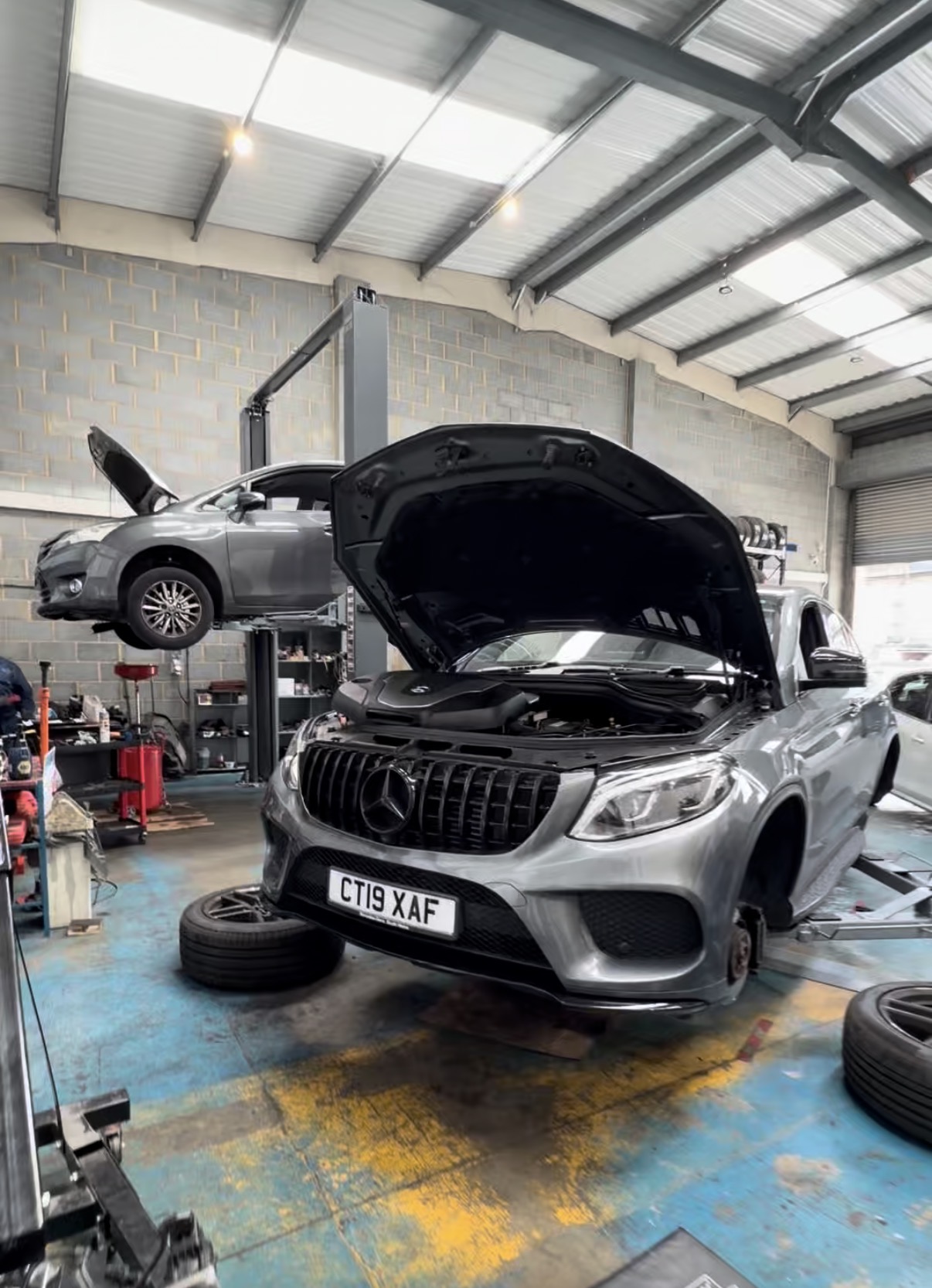 Mercedes with the bonnet up for electrical work at KITH Cars Garage & Bodyworks, Hackbridge